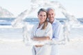 Composite image of happy couple hugging on the beach woman looking at camera Royalty Free Stock Photo