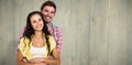 Composite image of happy couple hugging and looking at camera Royalty Free Stock Photo