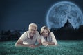 Composite image of happy couple lying smiling at camera