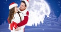 Composite image of happy couple in santa hats with full moon winter night in background, copy space Royalty Free Stock Photo