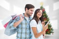 Composite image of happy couple with shopping bags and tablet Royalty Free Stock Photo