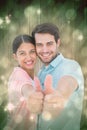 Composite image of happy couple showing thumbs up Royalty Free Stock Photo