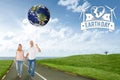 Composite image of happy couple walking holding hands Royalty Free Stock Photo