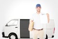 Composite image of happy delivery man holding cardboard box and clipboard Royalty Free Stock Photo