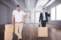 Composite image of happy delivery man leaning on trolley of boxes Royalty Free Stock Photo