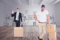 Composite image of happy delivery man leaning on trolley of boxes Royalty Free Stock Photo