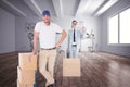 Composite image of happy delivery man leaning on trolley of boxes Royalty Free Stock Photo