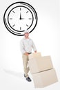 Composite image of happy delivery man pushing trolley of boxes Royalty Free Stock Photo