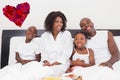 Composite image of happy family having breakfast in bed Royalty Free Stock Photo