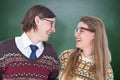 Composite image of happy geeky hipster couple looking at each other Royalty Free Stock Photo