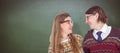 Composite image of happy geeky hipster couple looking at each other Royalty Free Stock Photo