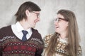 A Composite image of happy geeky hipster couple looking at each other Royalty Free Stock Photo