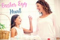 Composite image of happy girl showing easter egg to her mother Royalty Free Stock Photo