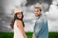 Composite image of happy hipster couple holding hands and smiling at camera Royalty Free Stock Photo