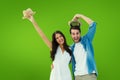 Composite image of happy hipster couple smiling at camera and cheering Royalty Free Stock Photo