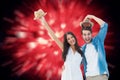 Composite image of happy hipster couple smiling at camera and cheering Royalty Free Stock Photo