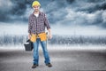 Composite image of happy male hanyman carrying toolbox