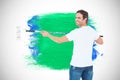 Composite image of happy man using paint roller Royalty Free Stock Photo