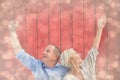 Composite image of happy mature couple with hands up Royalty Free Stock Photo