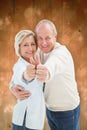 Composite image of happy mature couple showing thumbs up Royalty Free Stock Photo