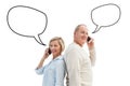 Composite image of happy mature couple talking on their phones Royalty Free Stock Photo