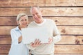 Composite image of happy mature couple using laptop Royalty Free Stock Photo