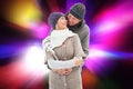 Composite image of happy mature couple in winter clothes embracing Royalty Free Stock Photo