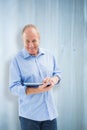 Composite image of happy mature man using his tablet pc Royalty Free Stock Photo