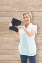 Composite image of happy mature woman pointing to tablet pc Royalty Free Stock Photo