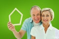 Composite image of happy older couple holding house shape Royalty Free Stock Photo