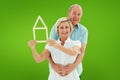 Composite image of happy older couple holding house shape Royalty Free Stock Photo