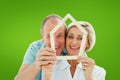 Composite image of happy older couple holding house shape Royalty Free Stock Photo