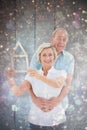 Composite image of happy older couple holding house shape Royalty Free Stock Photo