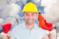 Composite image of happy repairman holding hammer and drill machine Royalty Free Stock Photo