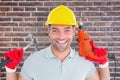 Composite image of happy repairman holding hammer and drill machine Royalty Free Stock Photo