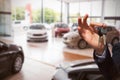 Composite image of happy seller holding car keys