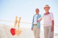 Composite image of happy senior couple walking on the pier Royalty Free Stock Photo