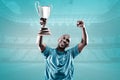 Composite image of happy sportsman looking up and cheering while holding trophy Royalty Free Stock Photo