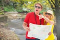 Composite image of happy tourist couple using map Royalty Free Stock Photo