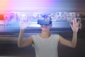 Composite image of happy woman gesturing while using virtual reality headset Royalty Free Stock Photo