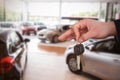 Composite image of happy woman receiving car keys Royalty Free Stock Photo