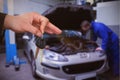 Composite image of happy woman receiving car keys Royalty Free Stock Photo