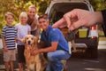 Composite image of happy woman receiving car keys Royalty Free Stock Photo