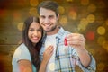 Composite image of happy young couple holding new house key Royalty Free Stock Photo