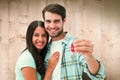 Composite image of happy young couple holding new house key Royalty Free Stock Photo