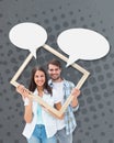 Composite image of happy young couple holding picture frame Royalty Free Stock Photo