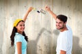 Composite image of happy young couple painting together Royalty Free Stock Photo