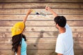 Composite image of happy young couple painting together Royalty Free Stock Photo