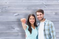 Composite image of happy young couple showing new house key Royalty Free Stock Photo