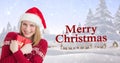 Composite image of happy young woman in santa hat embracing gift by christmas greeting